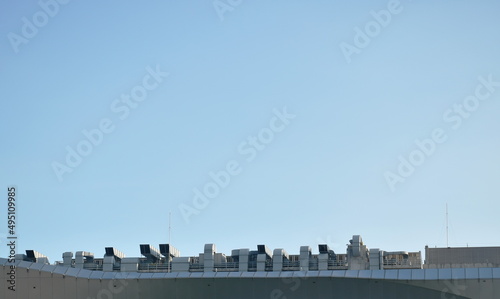 big ventilation chimney on building rooftop in sky background