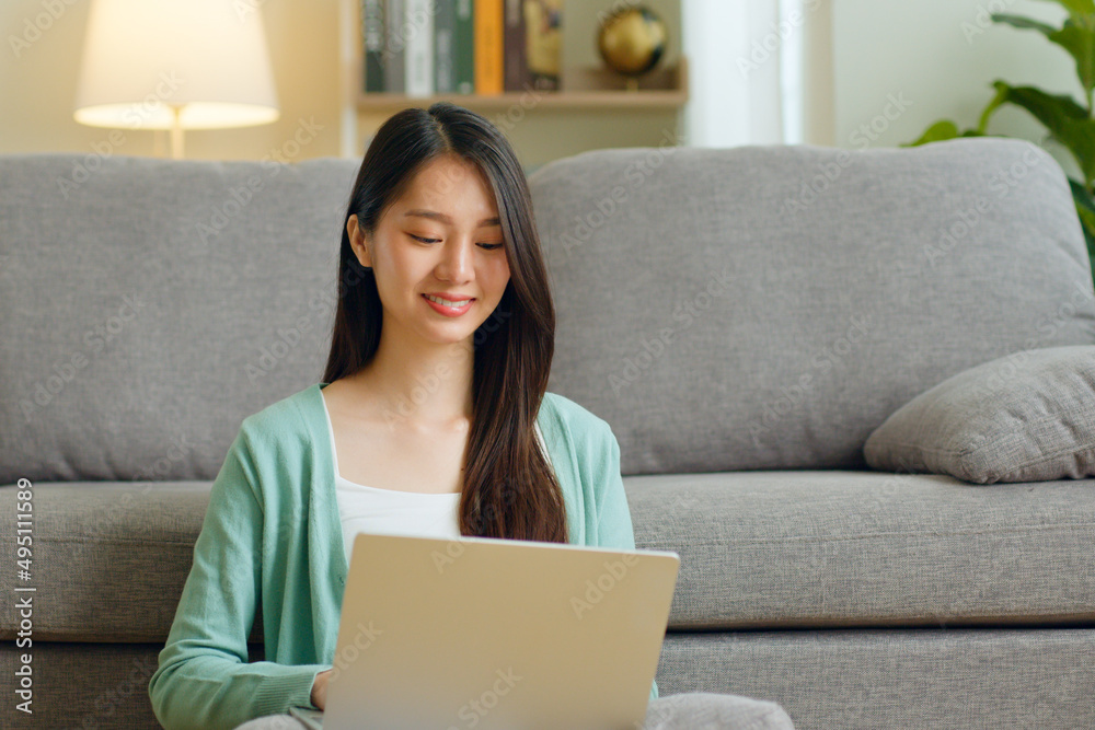 Young Asian woman using laptop computer for online working, studying, learning chatting in social media at home. Young Asian woman using laptop computer for online working, studying, learning chatting in social media at home.