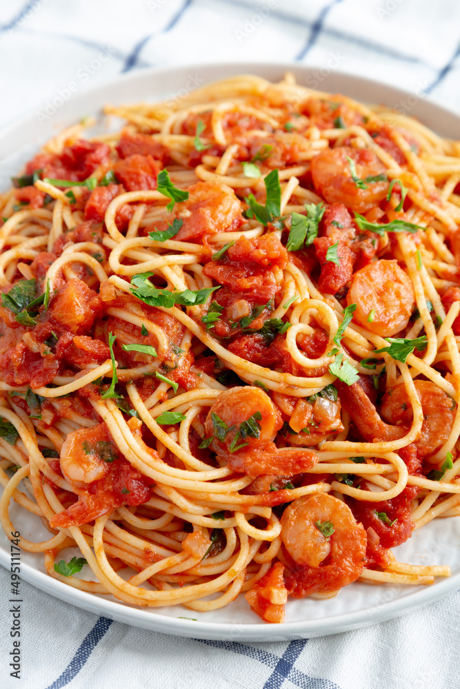 Homemade One-Pot Garlic Tomato Shrimp Pasta on a Plate, side view.