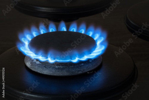 gas stove burns with blue flame, gas burner in the kitchen, utilities concept