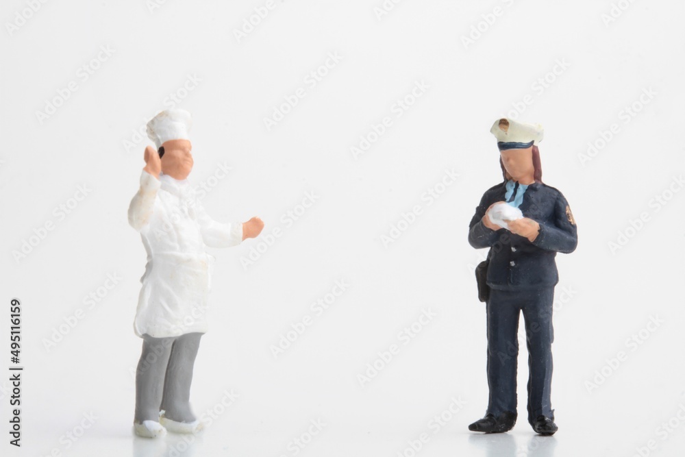 Miniature figurine of a policewoman making a fine to a cook Miniature figurine of a policewoman making a fine to a cook