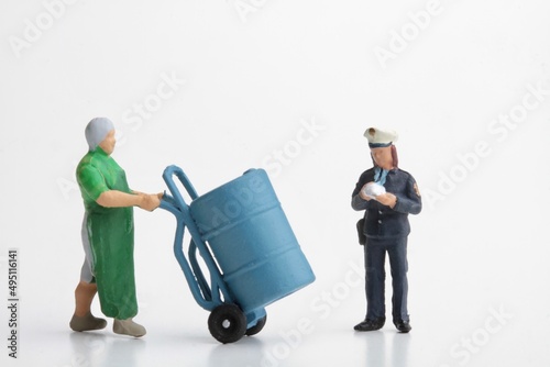 miniature figurines of a policewoman making a fine to a worker