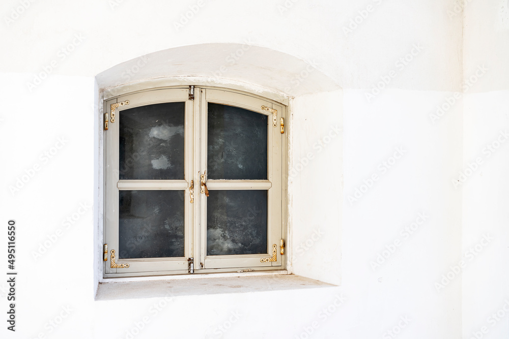 The old window of architecture of the XVII century on white wall