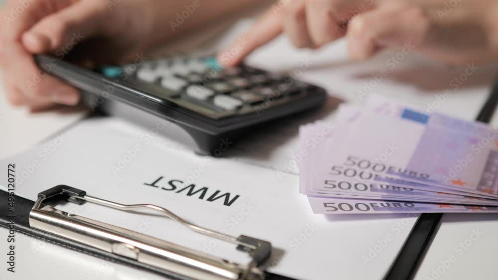 calculation of taxes in Germanspeaking language. A man's hand counts