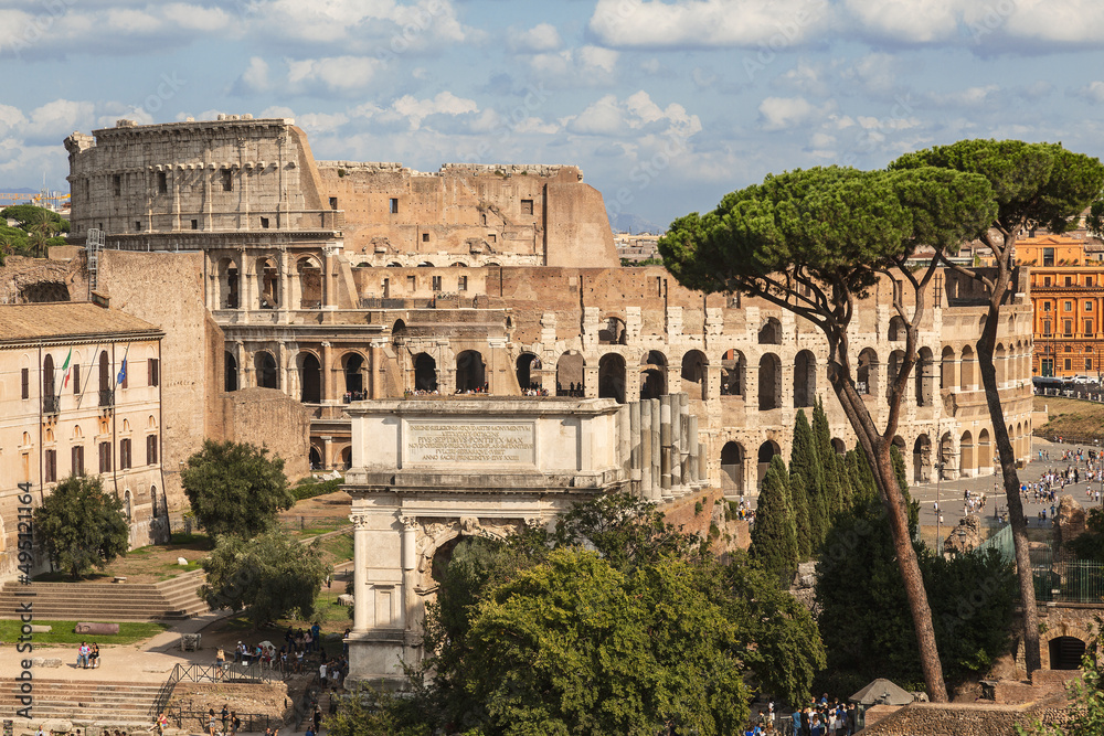 View of the ruins of the Roman Forum with the arch of Titus and the Colosseum. Rome, Italy