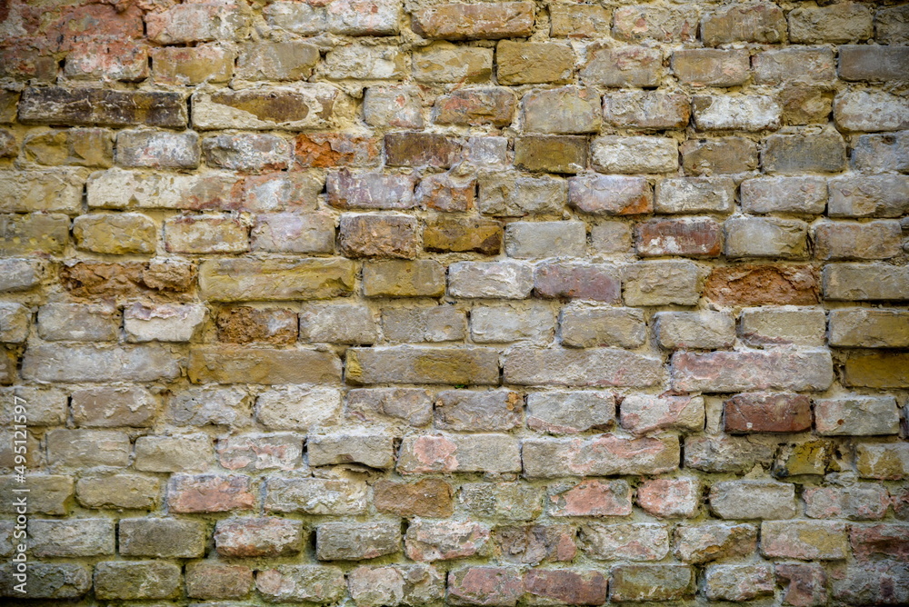 Fototapeta premium The background is an old brick wall. The wall is made of red ceramic bricks