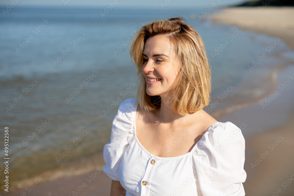 Beautiful girl in white dress at sunny day on a beach Beautiful girl in white dress at sunny day on a beach