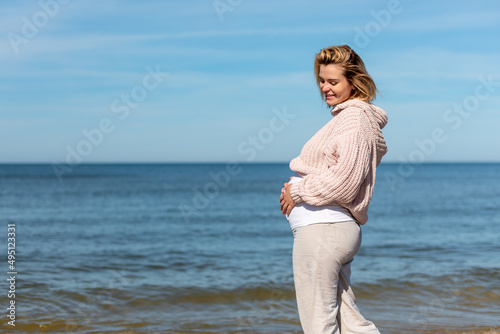 Girl relaxing on beach during pregnancy