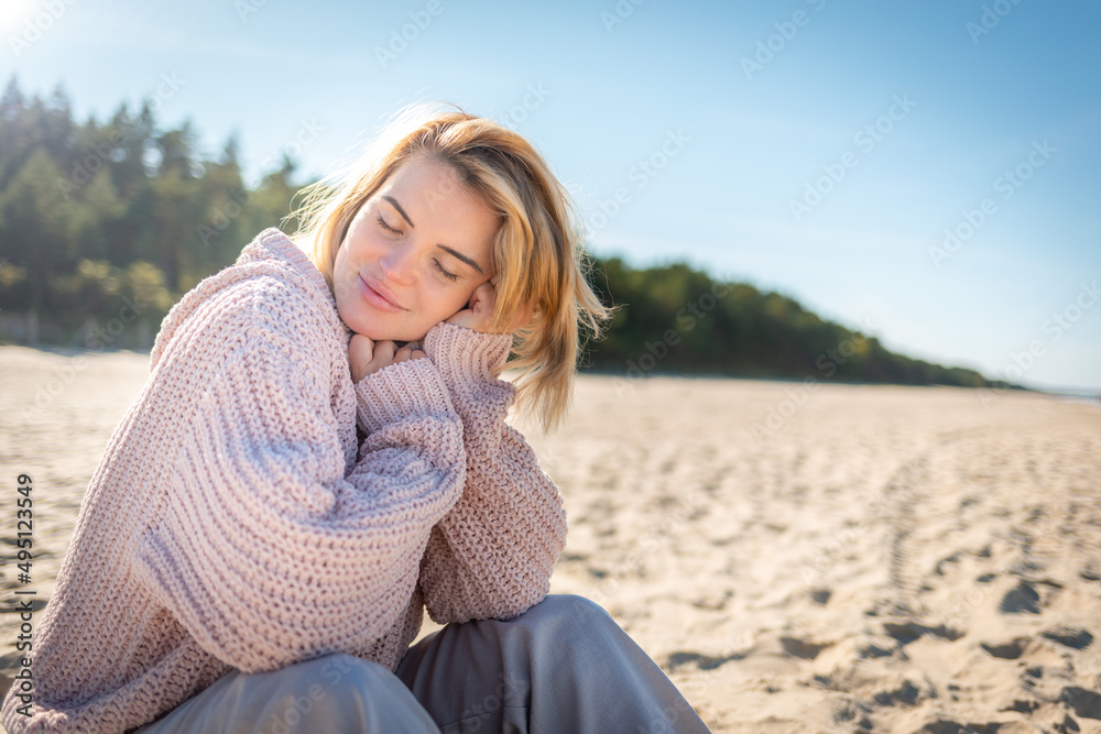 Happy woman on beach during cold spring weather Happy woman on beach during cold spring weather