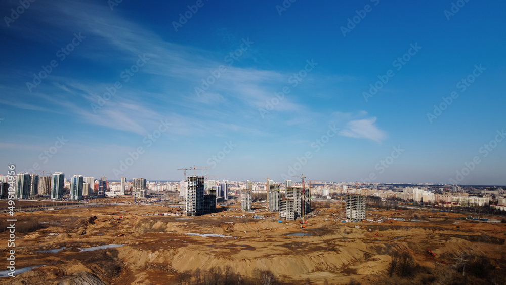 Construction of a modern city block Multi-storey buildings made of glass and concrete. Photographed in cloudy weather. Aerial photography.