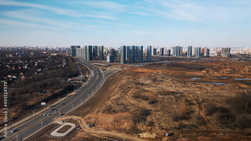 Construction of a modern city block Multi-storey buildings made of glass and concrete. Photographed in cloudy weather. Aerial photography.