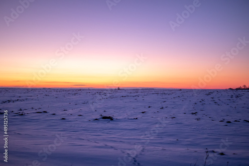 Winter field in sunset, purple colors background photo