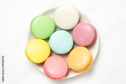 Colored macarons on a white background. Light and tasty dessert. traditional dessert