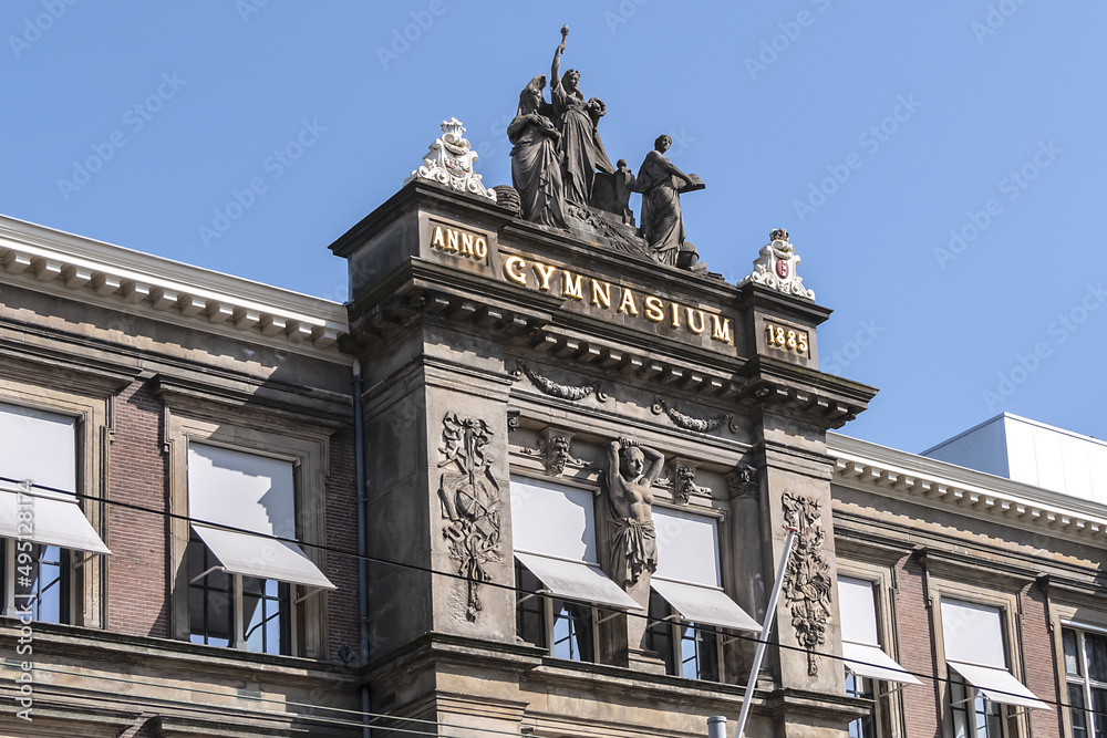 Architectural fragments of Barlaeus Gymnasium (established in 1884 - 1885) building in neo-classicism and eclecticism style. Amsterdam, the Netherlands.