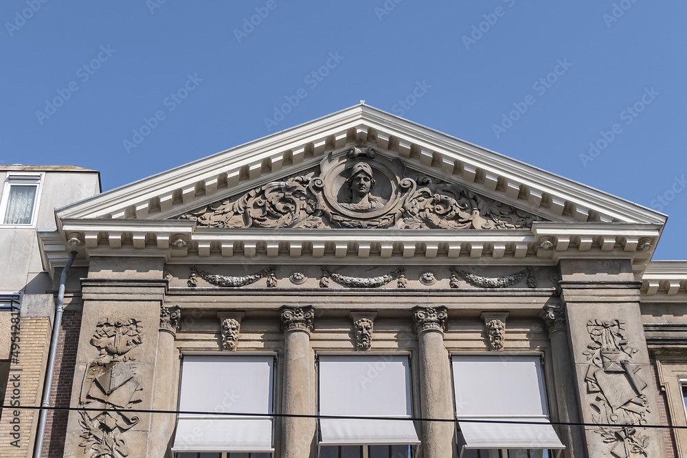 Architectural fragments of Barlaeus Gymnasium (established in 1884 - 1885) building in neo-classicism and eclecticism style. Amsterdam, the Netherlands.