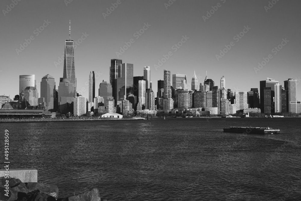 Jersey City, New Jersey, USA - December 22 2021: New York City downtown skyline. Financial district and World Trade Center. View from Statue of Liberty State Park.