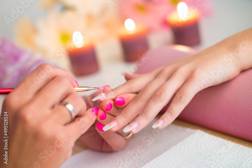Manicure process in beauty salon, making of artificial nails.