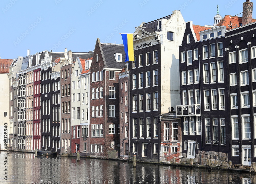 Amsterdam Damrak Canal Historic House Facades with Ukrainian Flag, Netherlands