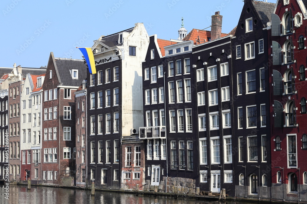 Amsterdam Damrak Canal Traditional House Facades with Ukrainian Flag, Netherlands