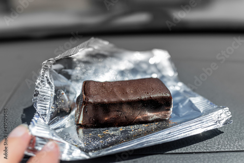 Storebought Russian cheesecake candy bar from Russia with chocolate glaze flavor macro closeup wrapped in foil photo