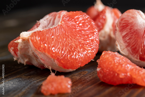 red ripe grapefruit on a cutting board