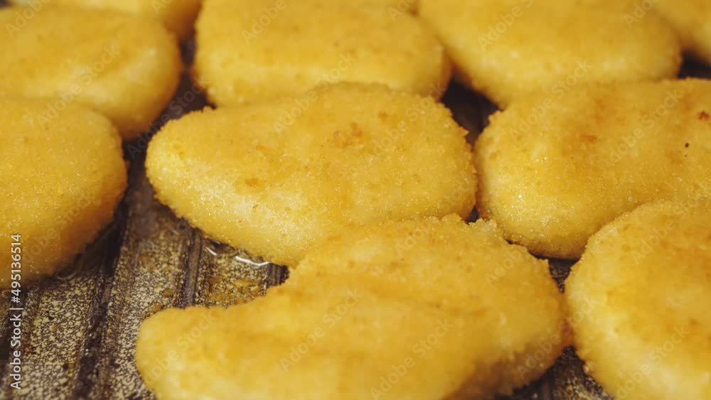 Crispy breaded nuggets fried in boiling oil. Close-up Crispy breaded nuggets fried in boiling oil. Close-up