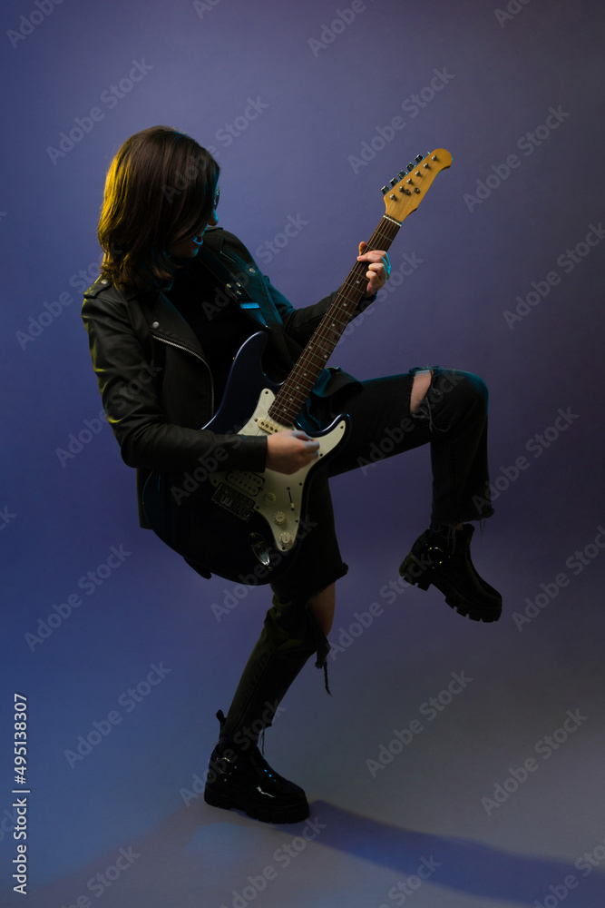 Fototapeta premium Female rock star playing the guitar