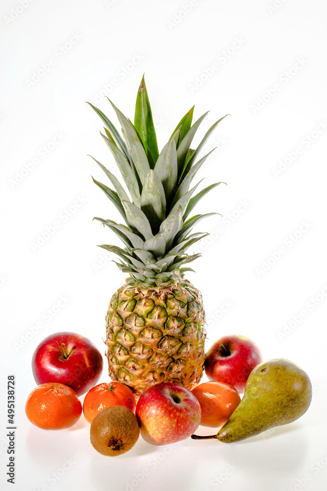 Beautiful view of pineapple, tangerines, apples, pear and kiwi isolated on white background. 