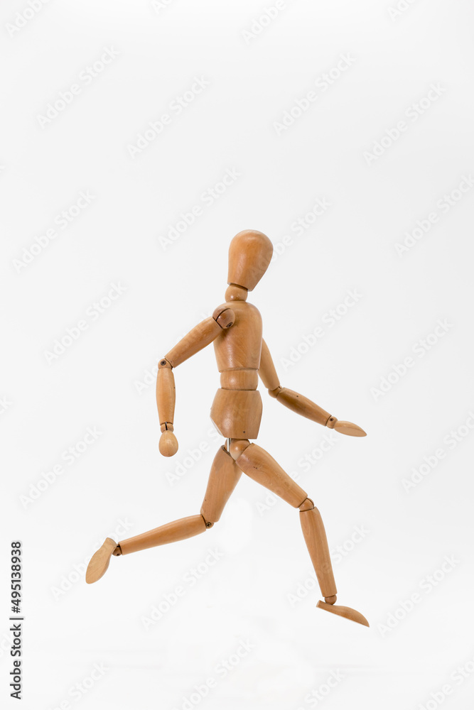 wooden doll in running position wooden doll in running position