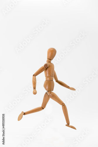wooden doll in running position