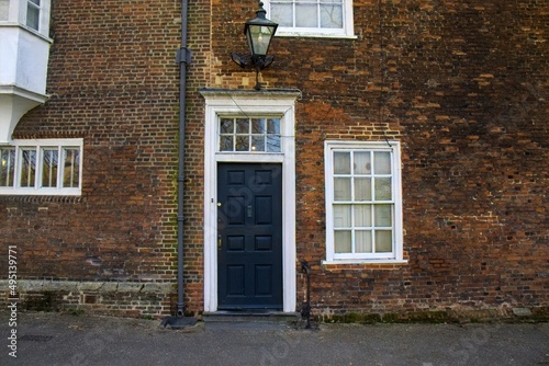 A dark blue door with a white frame in an old brick building in Ipswich, Suffolk, UK