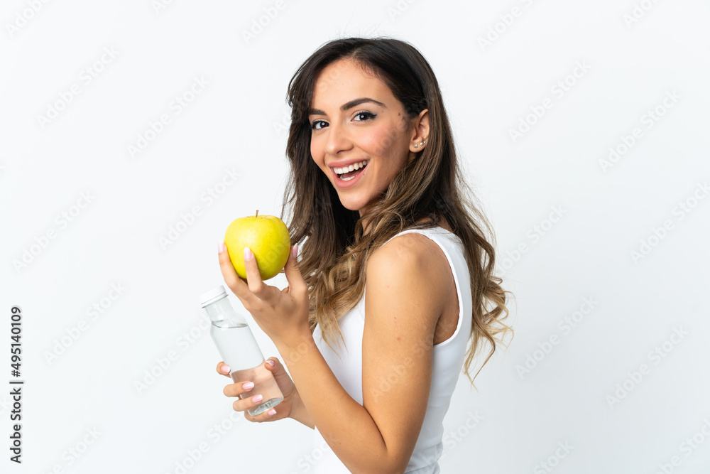 Young caucasian woman isolated on white background with an apple and with a bottle of water Young caucasian woman isolated on white background with an apple and with a bottle of water
