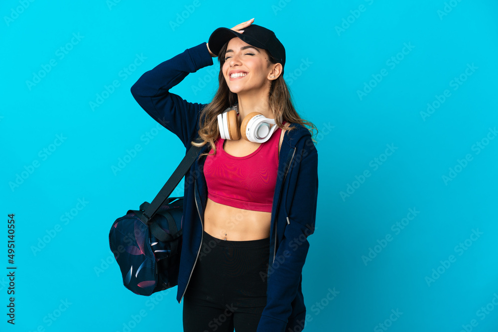 Young sport woman with sport bag isolated on blue background smiling a lot Young sport woman with sport bag isolated on blue background smiling a lot
