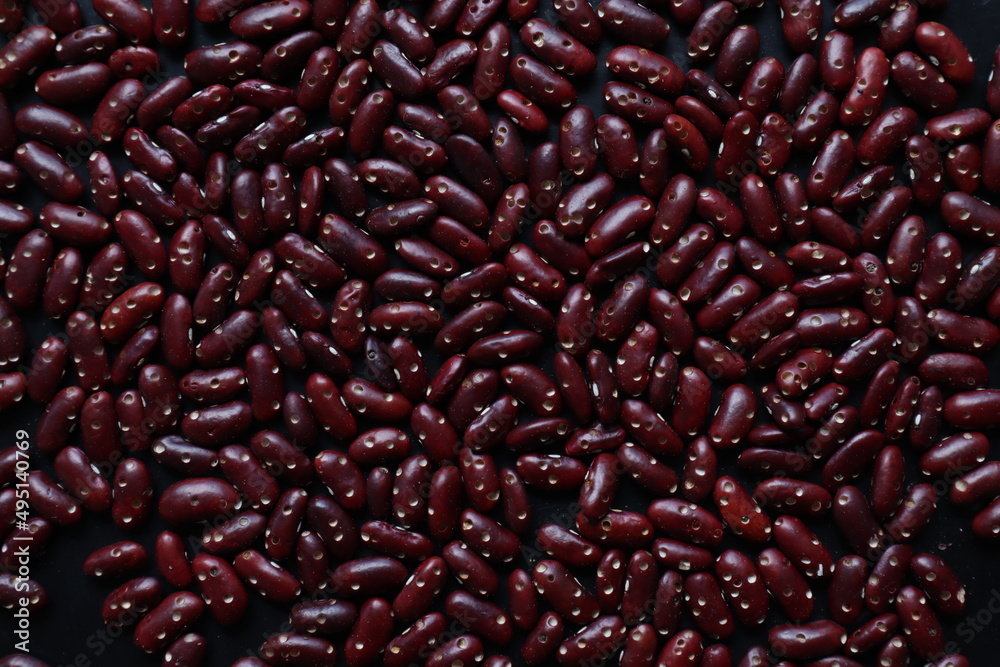 Background of grains of beans laying on a table to inspect bite marks caused by pests destroying pea seeds being prepared for planting. Organic red bean seeds destroyed by insect pests Background of grains of beans laying on a table to inspect bite marks caused by pests destroying pea seeds being prepared for planting. Organic red bean seeds destroyed by insect pests