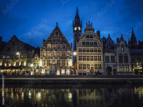 The historical city center of Ghent in Belgium in the evening reflected in a river