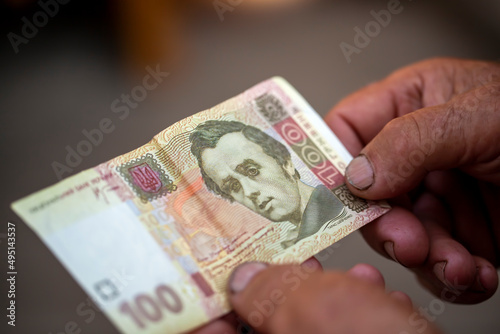 Ukrainian hryvnia in the hands of an old man