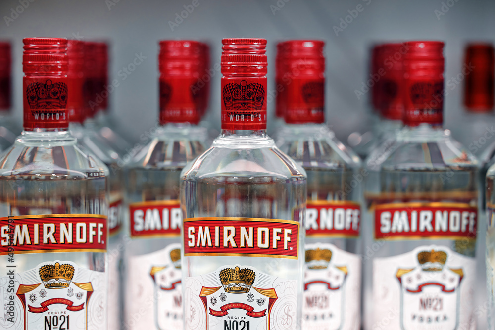 Russian vodka. Bottles of Smirnoff vodka on a shelf in duty free shop ...