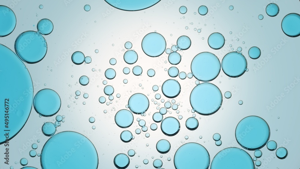 Blue oil drops floating in transparent fluid against pale blue background | Background for body care gel commercial shot