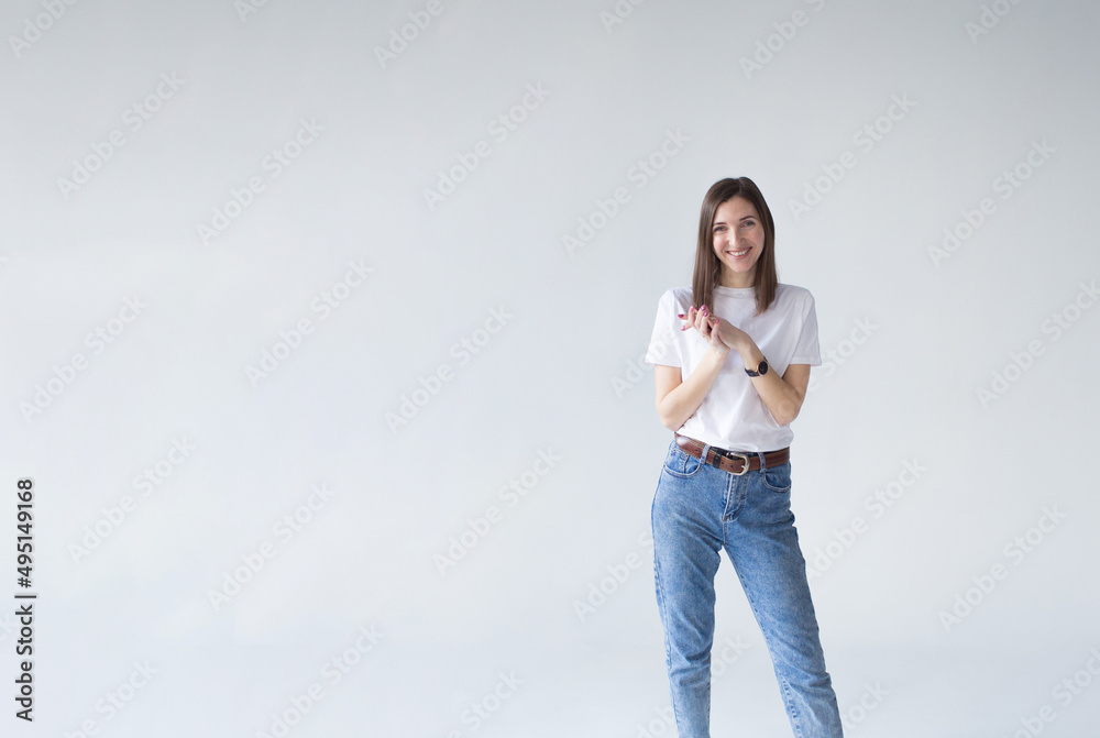 Portrait of smiling businesswoman standing with her hands folded and looking at the camera isolated on a white background Portrait of smiling businesswoman standing with her hands folded and looking at the camera isolated on a white background