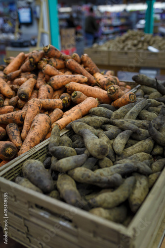 Fresh carrots and beetroots in boxes in grocery department store, local shop, supermarket. Organic food, farm vegetables