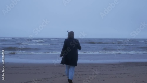 Girl goes to the ocean when it's cold outside, sea, beach, coast, cold rain, sad woman