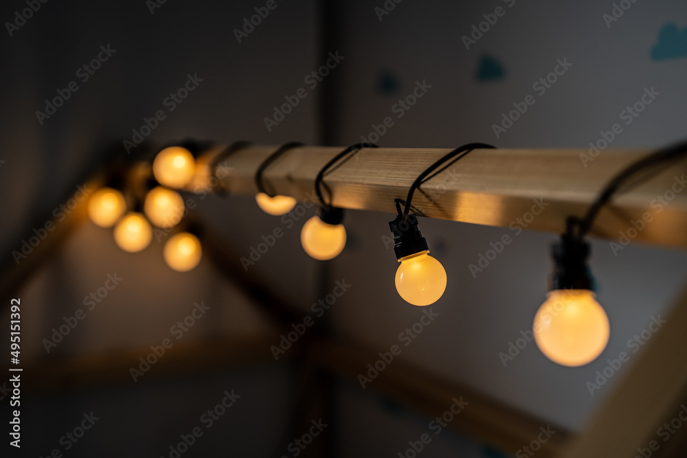 lights - garland - children's room - warm light on a wooden house