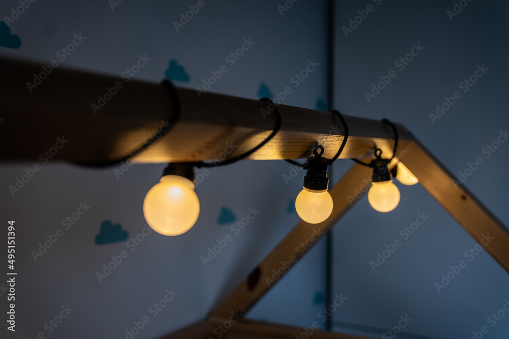 lights - garland - children's room - warm light on a wooden house