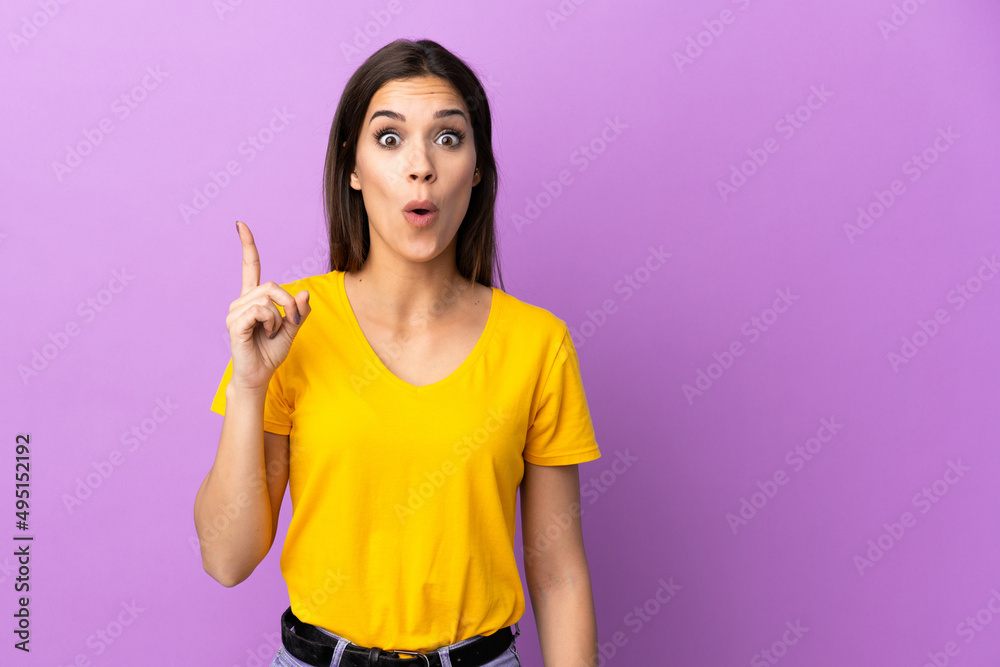 Young caucasian woman over isolated background intending to realizes the solution while lifting a finger up Young caucasian woman over isolated background intending to realizes the solution while lifting a finger up