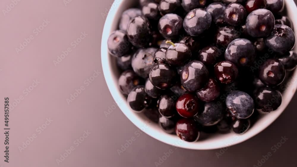 Slow motion of fresh blueberries in a white bowl. Space for text. The concept of healthy breakfast. copy space. Slow motion of fresh blueberries in a white bowl. Space for text. The concept of healthy breakfast. copy space.