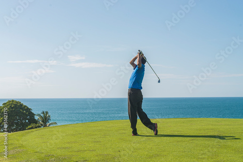 Latin golf instructor practicing his swing