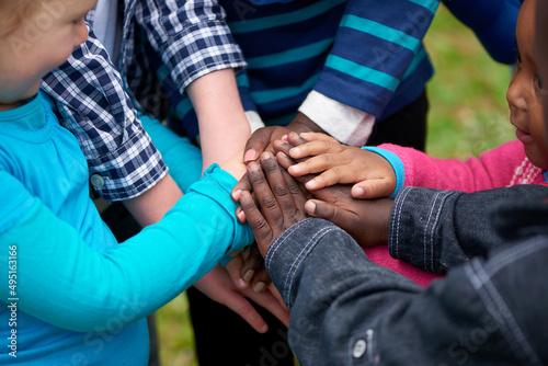 Friends forever. Shot of a diverse group of children standing with their hands together. © Cameron Mcdonald/peopleimages.com