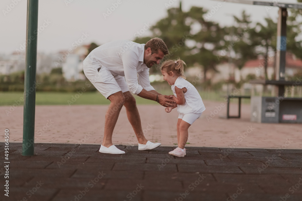 An elderly man in casual clothes with his daughter spends time together in the park on vacation. Family time. Selective focus An elderly man in casual clothes with his daughter spends time together in the park on vacation. Family time. Selective focus