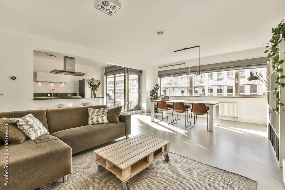 Interior of a cozy bright living room with a street view and a small