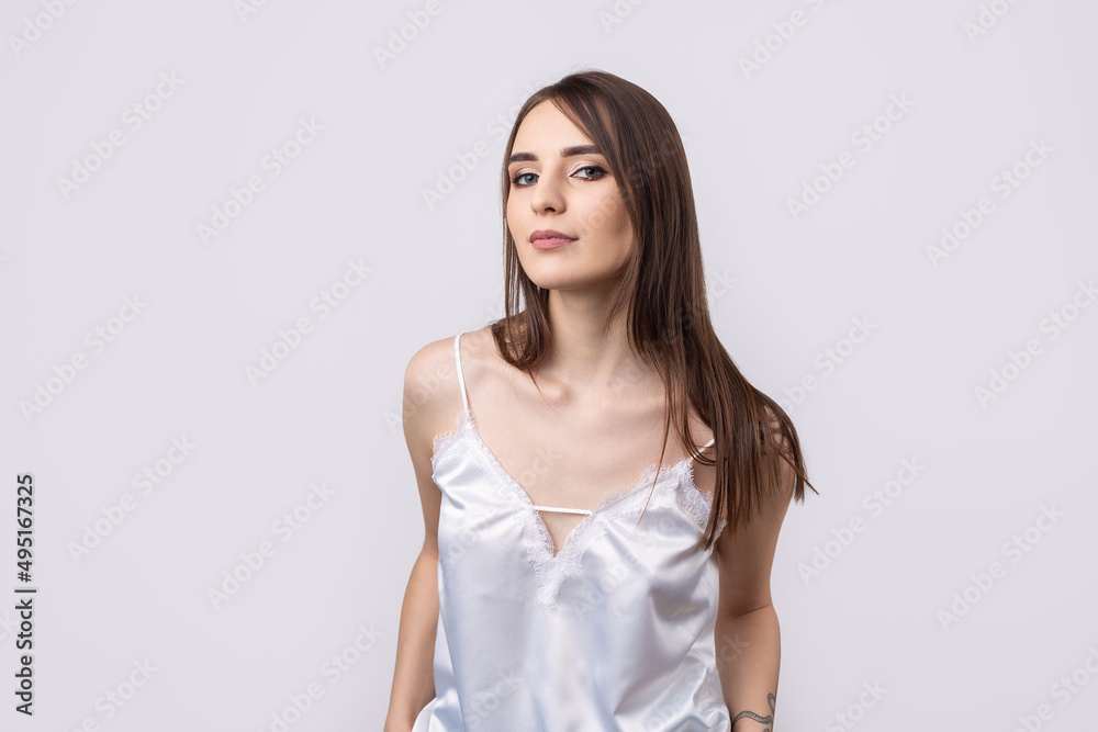 Beautiful smiling woman with clean skin, natural make-up and white teeth on a gray background Beautiful smiling woman with clean skin, natural make-up and white teeth on a gray background